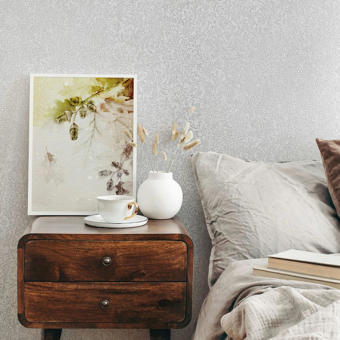 Marburg Ritus 35530 Tone-on-tone light gray to white wallpaper with a dense, small-scale botanical scroll pattern of twm wallpaper on a bedroom feature wall.