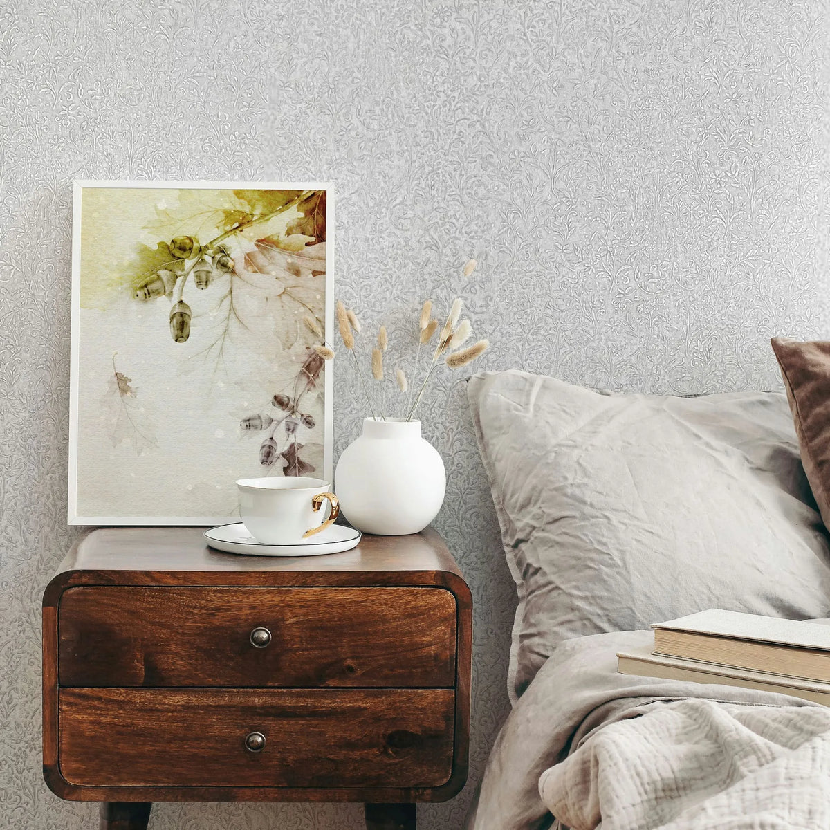 Marburg Ritus 35530 Tone-on-tone light gray to white wallpaper with a dense, small-scale botanical scroll pattern of twm wallpaper on a bedroom feature wall.