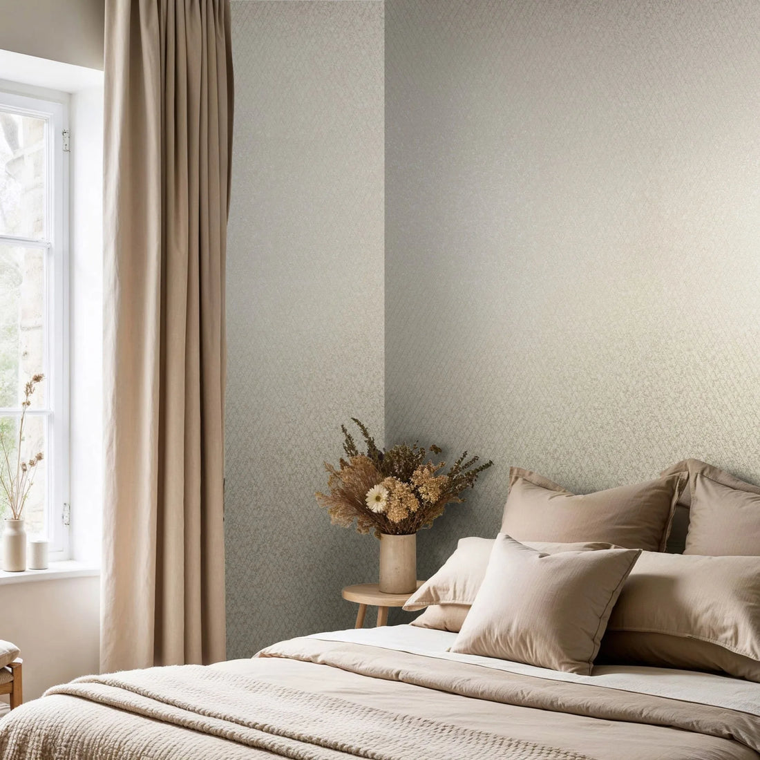 Marburg Ritus 35535 Bedroom scene showing light beige geometric wallpaper on two walls beside a window with curtains, a bed with neutral pillows and bedding, and a bedside table holding a vase of dried flowers.
