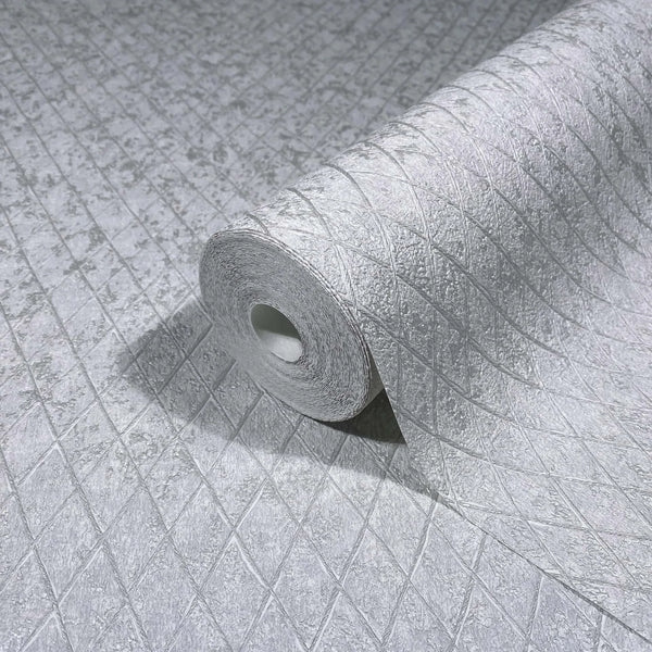 Marburg Ritus 35536 Close-up of a gray textured wallpaper roll with an embossed diamond lattice pattern resting on the same unrolled wallpaper.