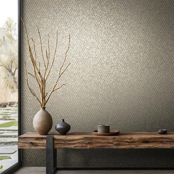 Marburg Ritus 35540 Wide view of a dark wallpaper featuring a small gold diamond lattice pattern. A rustic wood bench with ceramic vessels, including a tall vase with bare branches, sits in front of the wall next to a floor-to-ceiling window.
