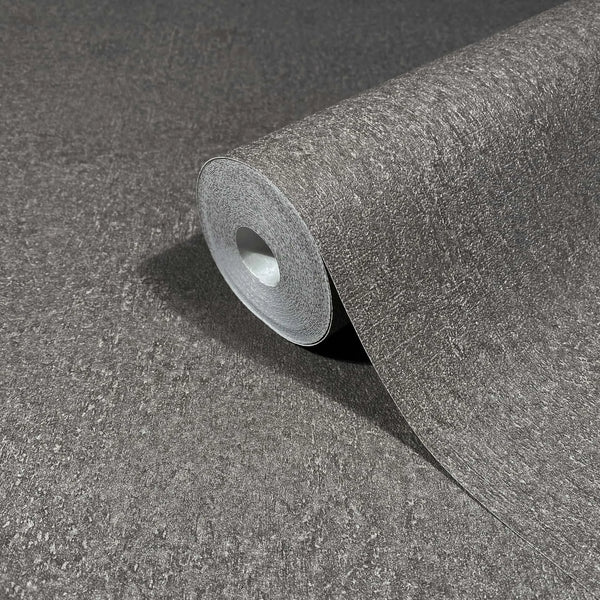Marburg Ritus 35541 Close-up of a gray textured wallpaper roll resting on matching unrolled wallpaper.