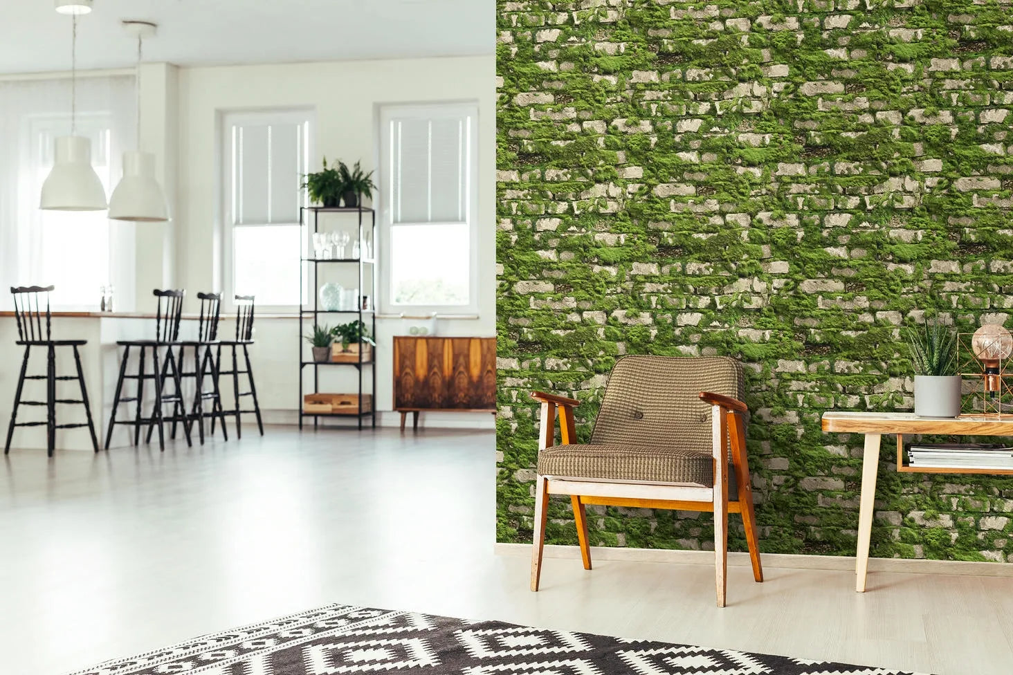 Marburg Struktura 45732 Green mossy stone brick effect wallpaper on a feature wall beside a wood armchair and console table, with plants, a table lamp, rug, shelving, bar stools, pendant lights, and windows in an open-plan room.