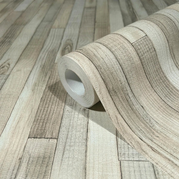 Marburg Struktura 45734 Close-up of a wallpaper roll partially unrolled, showing a beige faux wood plank pattern on a matching surface.