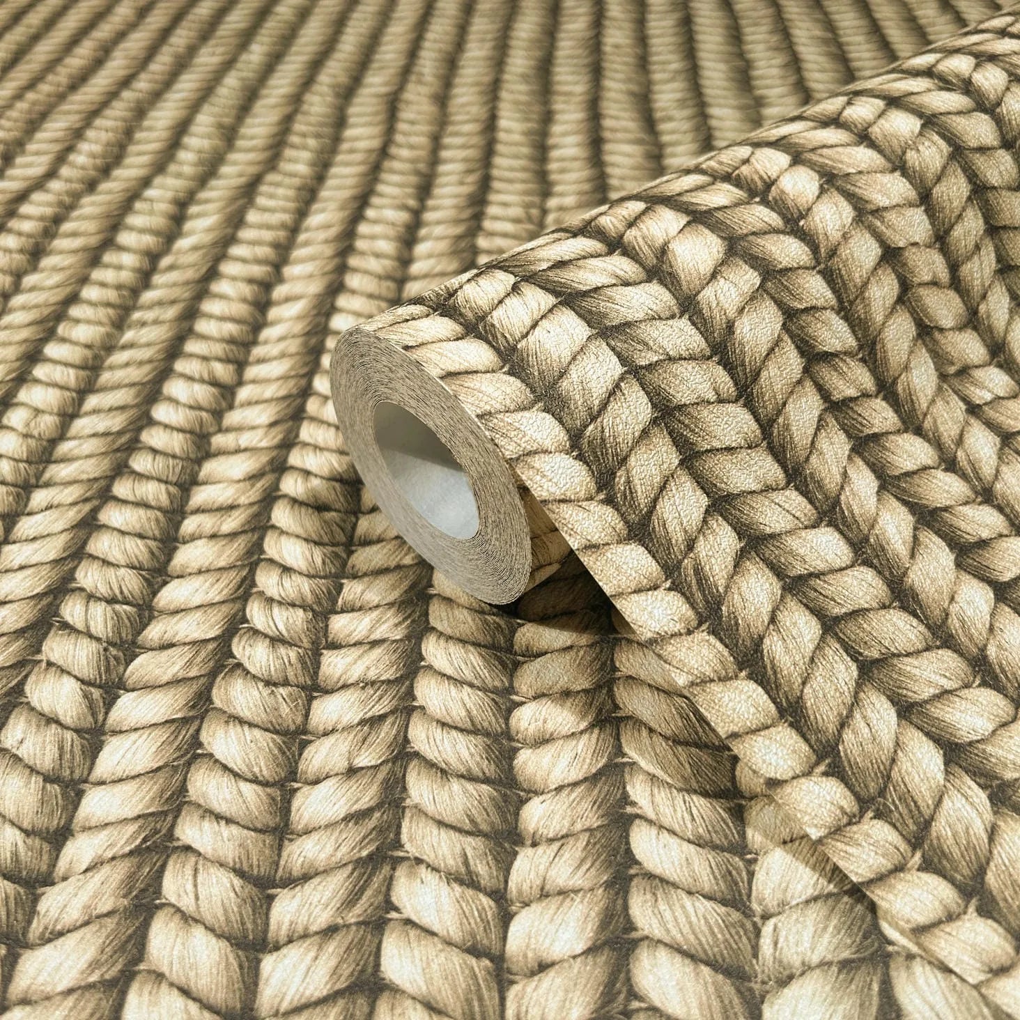 Marburg Struktura 45750 Close-up of a wallpaper roll resting on matching wallpaper featuring a beige and brown braided rope pattern.