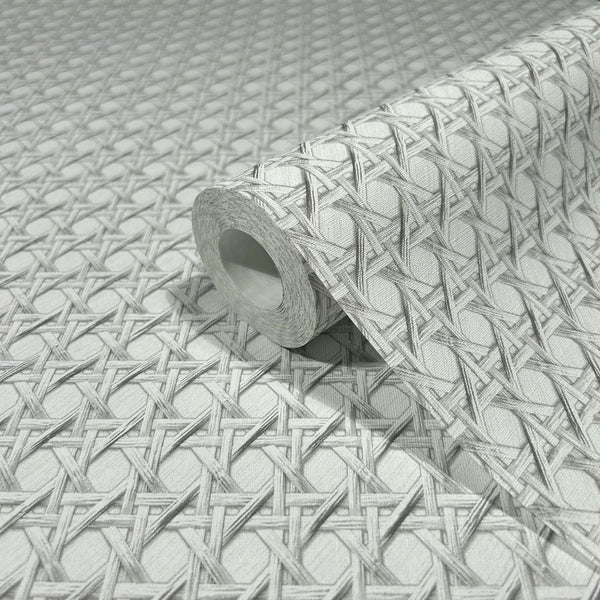 Marburg Struktura 45754 Close-up of a wallpaper roll resting on matching paper, showing a gray and white interlaced lattice pattern with diamond shapes.