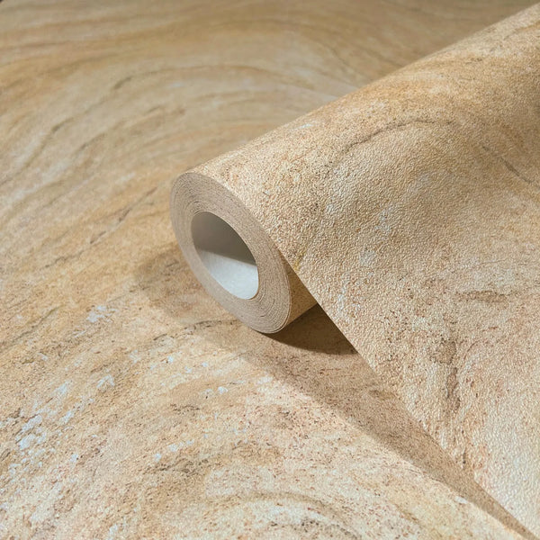 Marburg Struktura 45755 Close-up of a beige stone-effect wallpaper roll resting on the same pattern, showing mottled swirls and speckles.