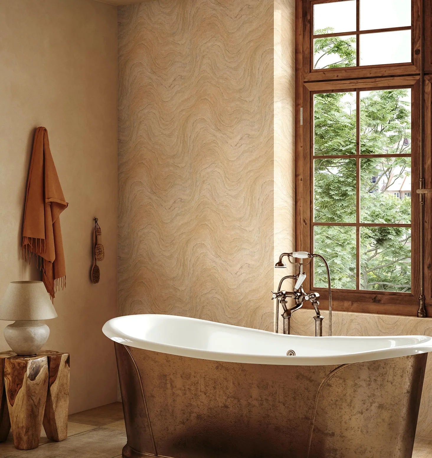 Marburg Struktura 45755 Bathroom scene featuring a beige wavy-pattern wallpaper on a feature wall beside a wood-framed window. A freestanding tub with exposed faucet sits in front, with a hanging towel and bath brushes, a small lamp, and a wood stump side table visible.
