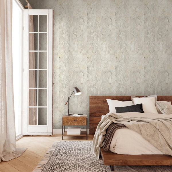 Marburg Struktura 45768 Stone-effect textured wallpaper with irregular veining and mottled shading in light beige-gray tones wallpaper on a bedroom feature wall.