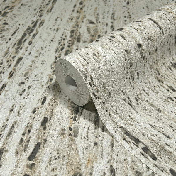 Marburg Travertino 33351 A partially unrolled wallpaper roll showing a beige and gray travertine stone-effect design with porous markings and streaked texture.
