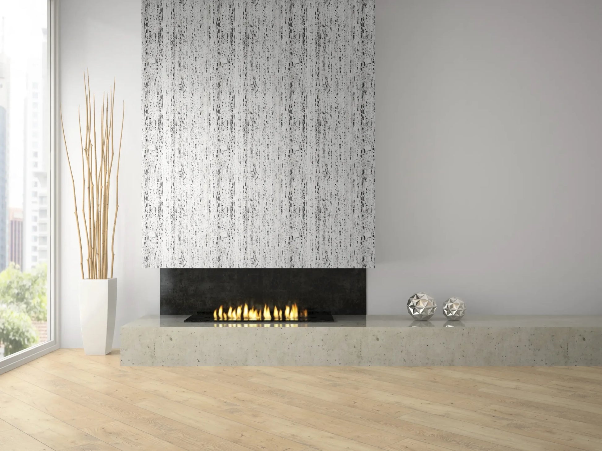 Marburg Travertino 33353 Gray-on-white abstract vertical streak wallpaper covers the chimney breast above a modern linear fireplace on a concrete hearth, with a tall white planter holding sticks and two metallic decorative spheres nearby.