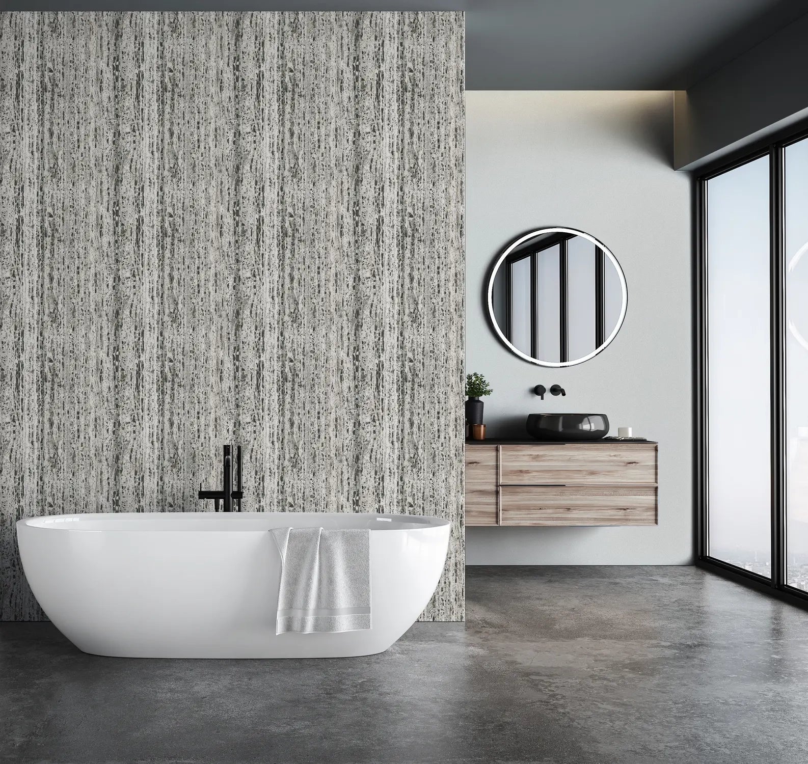 Marburg Travertino 33354 Gray vertical striated wallpaper on a feature wall behind a freestanding bathtub in a modern bathroom with a floating wood vanity, round mirror, and large windows.