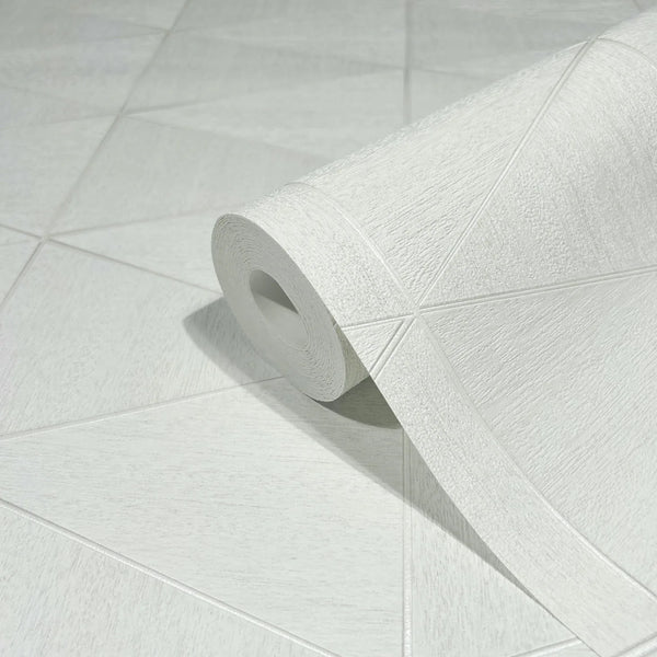 Marburg Travertino 33356 Close-up of a white textured wallpaper roll resting on matching wallpaper with large triangular shapes and raised lines.