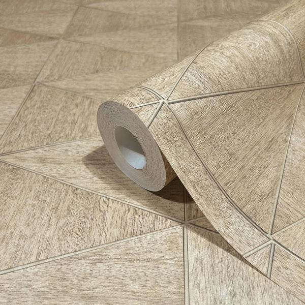 Marburg Travertino 33359 Wallpaper roll in beige and brown with a wood-textured geometric pattern of intersecting lines forming triangles, shown partially unrolled on a matching surface.