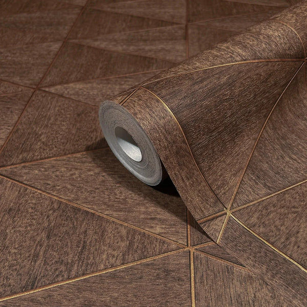 Marburg Travertino 33361 Close-up of a brown geometric wallpaper roll with thin gold-toned lines forming triangles, shown on a matching unrolled sheet.