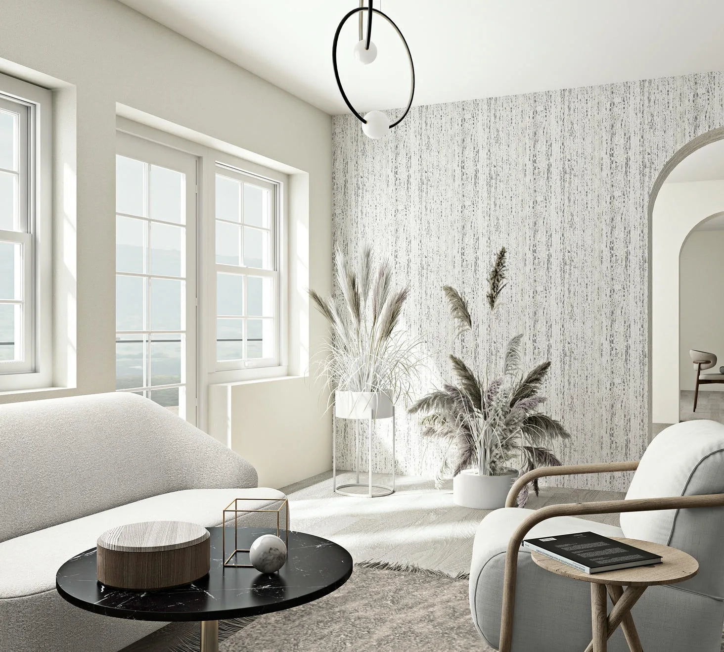 Marburg Travertino 33364 Bright living room featuring a white and gray vertically striated wallpaper on one wall, with large windows, a sofa, an armchair, a round black coffee table, indoor grasses in planters, and an arched doorway in view.