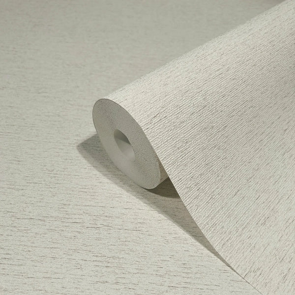Marburg Travertino 33367 Close-up of a light beige textured wallpaper roll on a matching surface, showing fine horizontal striations.