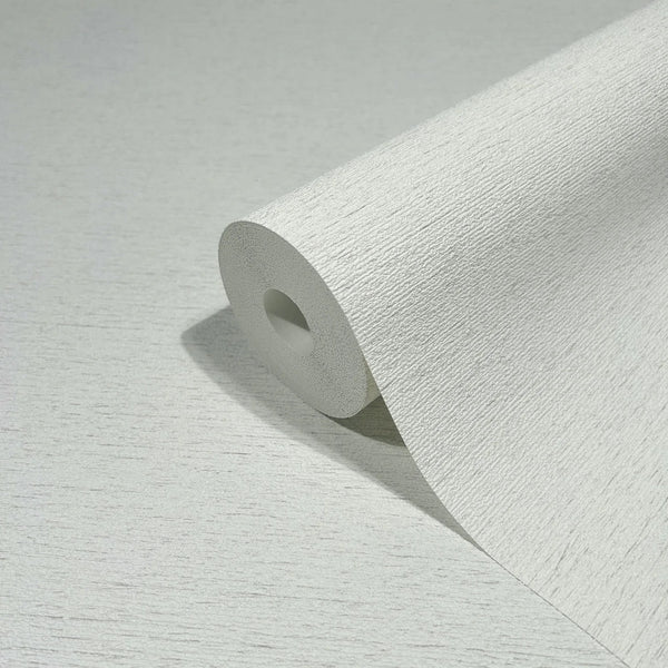 Marburg Travertino 33368 Close-up product shot of a white wallpaper roll showing a fine horizontal striated texture, resting on the same wallpaper.