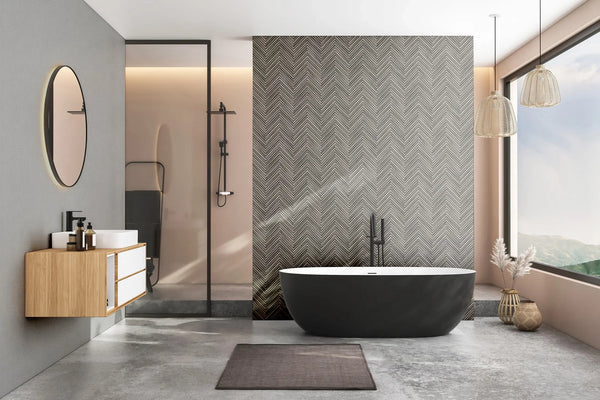 Marburg Travertino 33370 Gray chevron-patterned wallpaper is used as a feature wall behind a freestanding bathtub in a modern bathroom with a glass shower, floating vanity, pendant lights, and a large window.