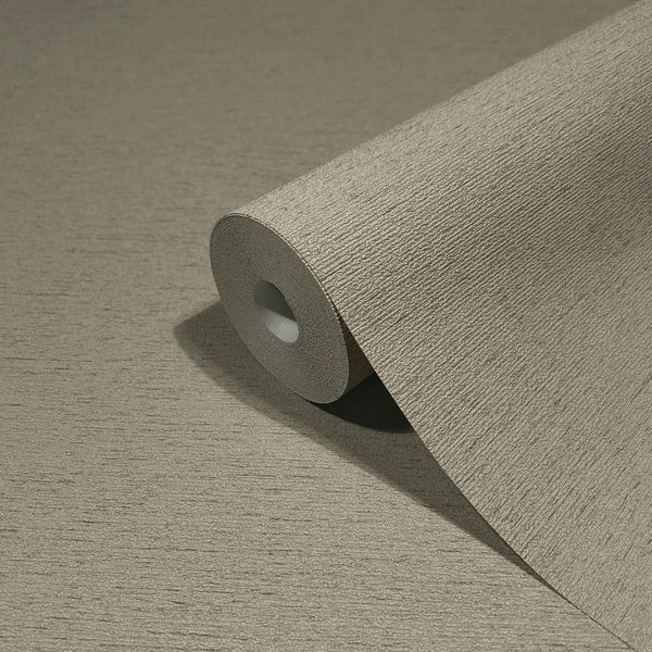 Marburg Travertino 33371 Close-up of a single wallpaper roll on a matching unrolled sheet, showing a warm grey-brown textured surface with fine horizontal lines.
