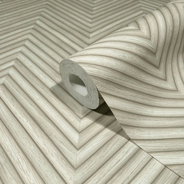 Marburg Travertino 33373 A wallpaper roll resting on matching beige chevron-patterned paper with fine striated lines forming V-shaped bands.