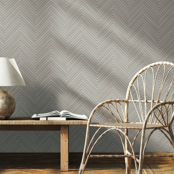 Marburg Travertino 33374 Gray wallpaper with a subtle chevron herringbone pattern formed by fine parallel lines wallpaper on a styled interior feature wall.