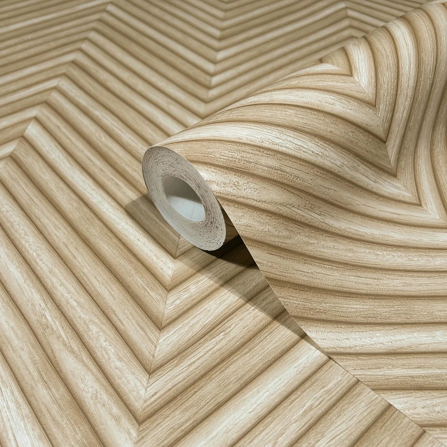 Marburg Travertino 33376 Beige wallpaper roll on a matching unrolled sheet, showing V-shaped chevron bands with a subtle linear grain and depth effect.