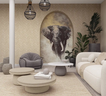 Marburg Travertino 33376 Living room scene with beige herringbone wallpaper and an arched niche featuring an elephant mural, styled with a light sofa, round coffee tables, a gray armchair, pendant lights, a rug, and potted plants.