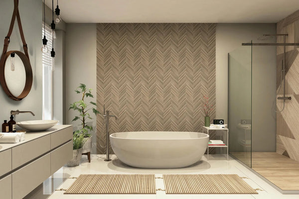Marburg Travertino 33377 Bathroom interior featuring a brown chevron-pattern wallpaper as a feature wall behind a freestanding oval bathtub, with a glass shower on the right and a vanity with round mirror on the left.