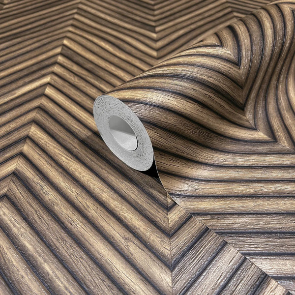Marburg Travertino 33378 Close-up of a partially unrolled wallpaper roll on matching wallpaper showing a brown woodgrain-look chevron pattern with narrow diagonal ribs.