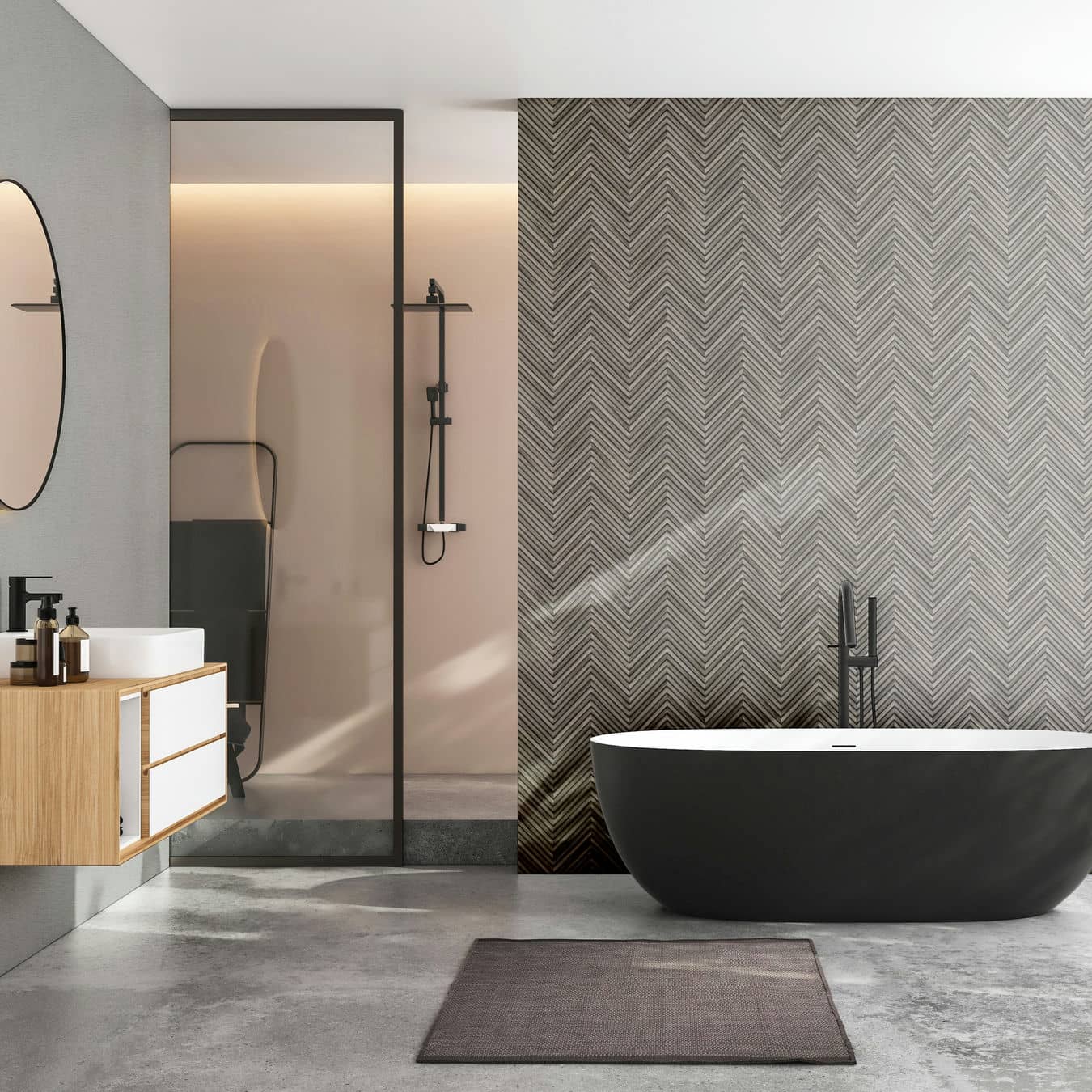 Marburg Travertino 33380 Bathroom scene showing a gray chevron wallpaper feature wall behind a black freestanding bathtub, with a glass shower and a floating vanity with sink and mirror at the side.