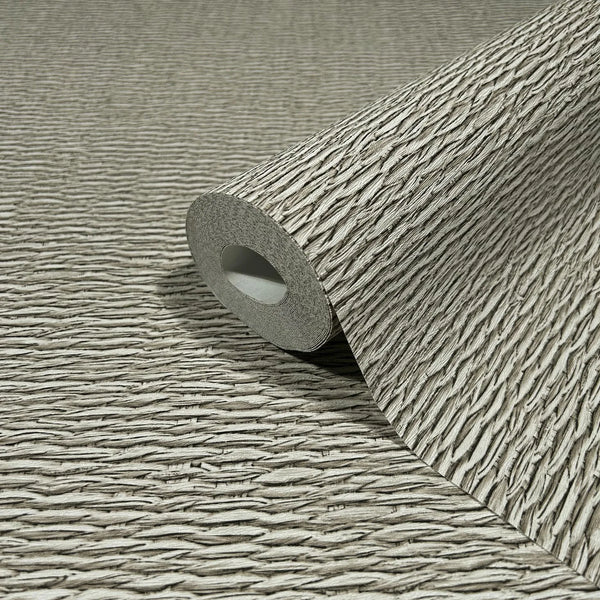 Marburg Travertino 33383 Close-up of a beige and brown textured wallpaper roll with irregular horizontal ridges, partially unrolled on the same pattern.