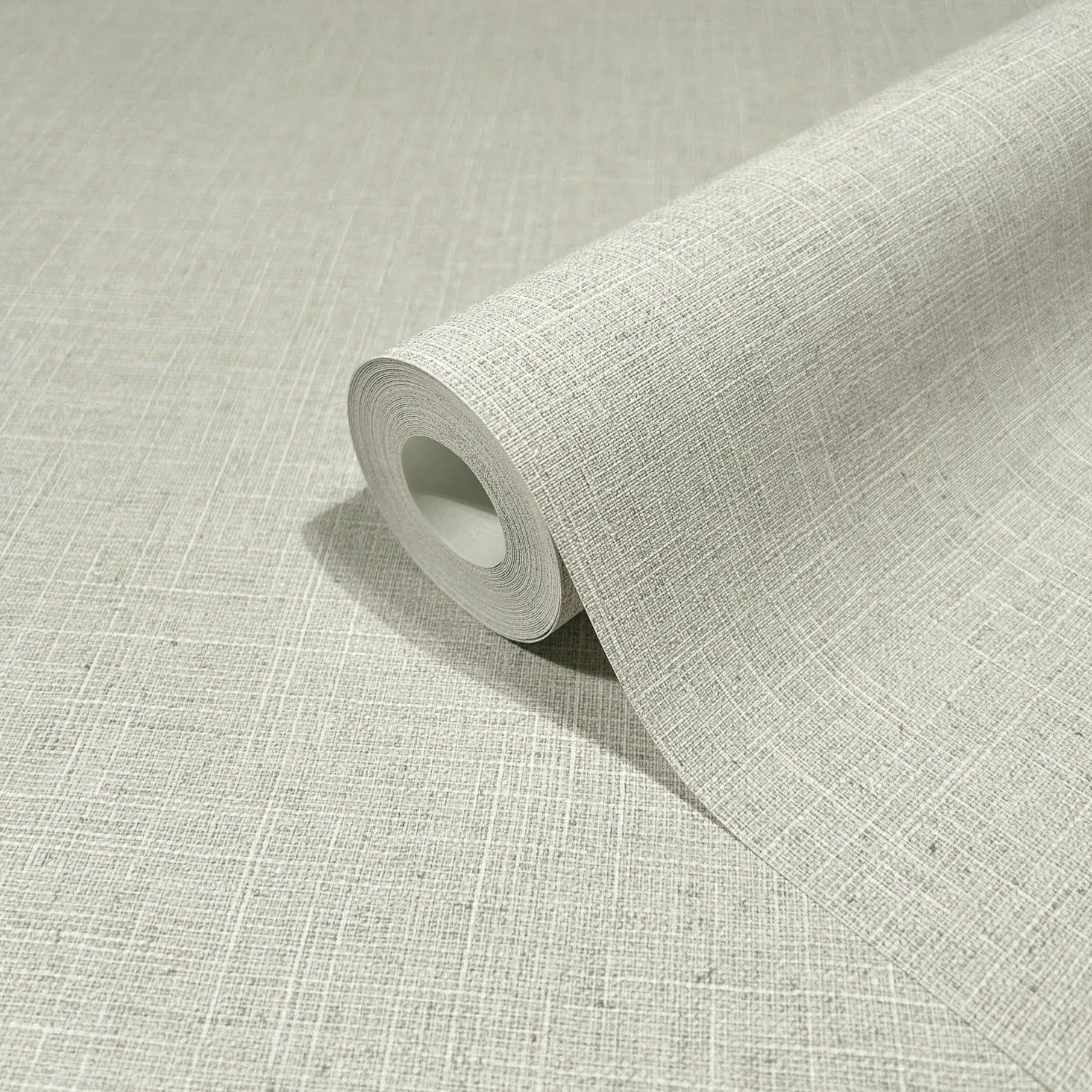 Marburg Travertino 33388 A single wallpaper roll on an unrolled sheet showing a light beige-gray crosshatch pattern with fine intersecting lines.