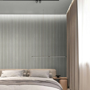 Marburg Travertino 33395 Bedroom scene featuring a silver vertical ribbed wallpaper behind a low upholstered bed, with a slim horizontal light above the headboard, a wood bedside table, and floor-length curtains.