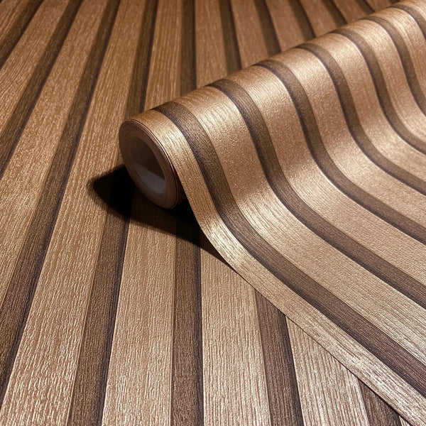 Marburg Travertino 33397 Close-up of a metallic copper and dark brown striped wallpaper roll resting on the same pattern, showing a textured finish.