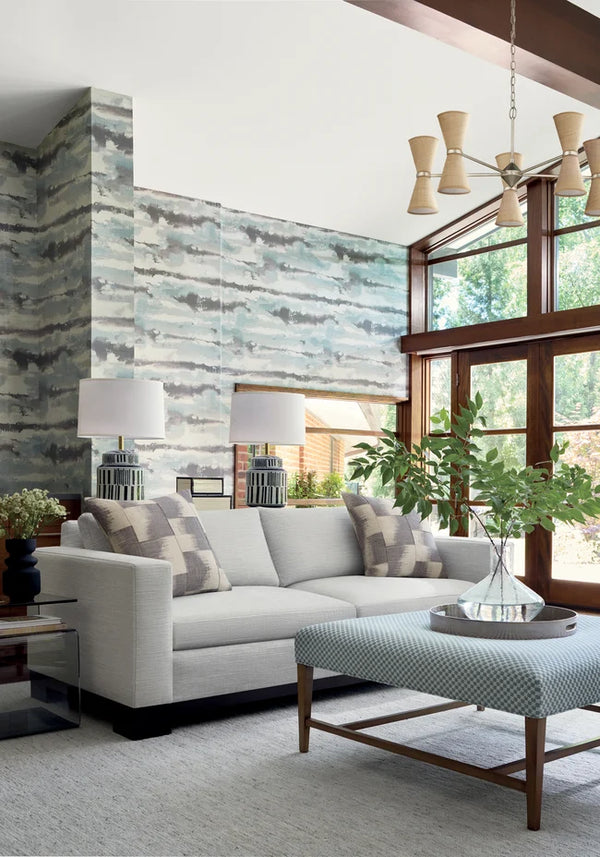 Thibaut Silver Lining wallpaper with Abaca on Foil shown on a feature wall in a contemporary lounge.