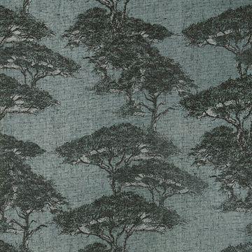 Thibaut Torrey Pines wallpaper in Mineral T24434 with layered pine trees on a dusty blue linen-mesh texture.