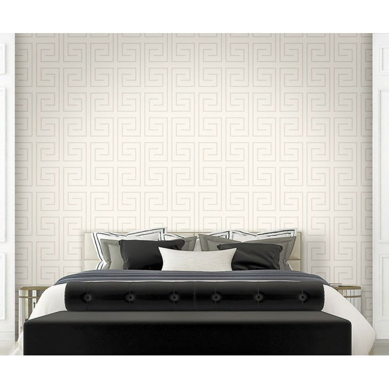 Bedroom with a black bed and white bedding against a geometric patterned wall.