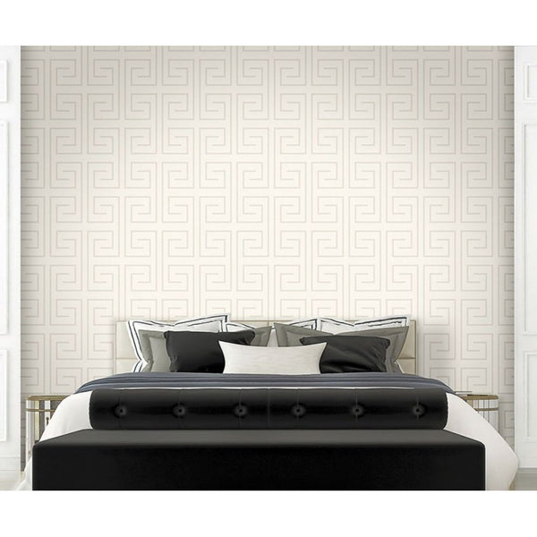 Bedroom with a black bed and white bedding against a geometric patterned wall.
